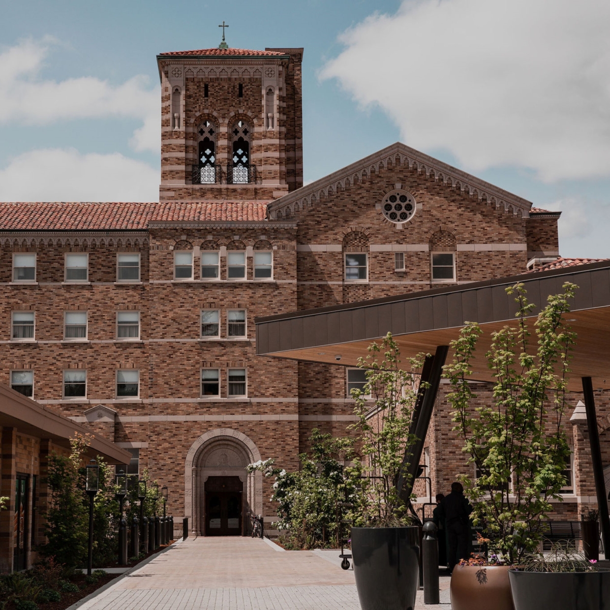 Exterior view of main entrance to The Lodge at St. Edward Park hotel. The former seminary's bell tower is featured prominently.