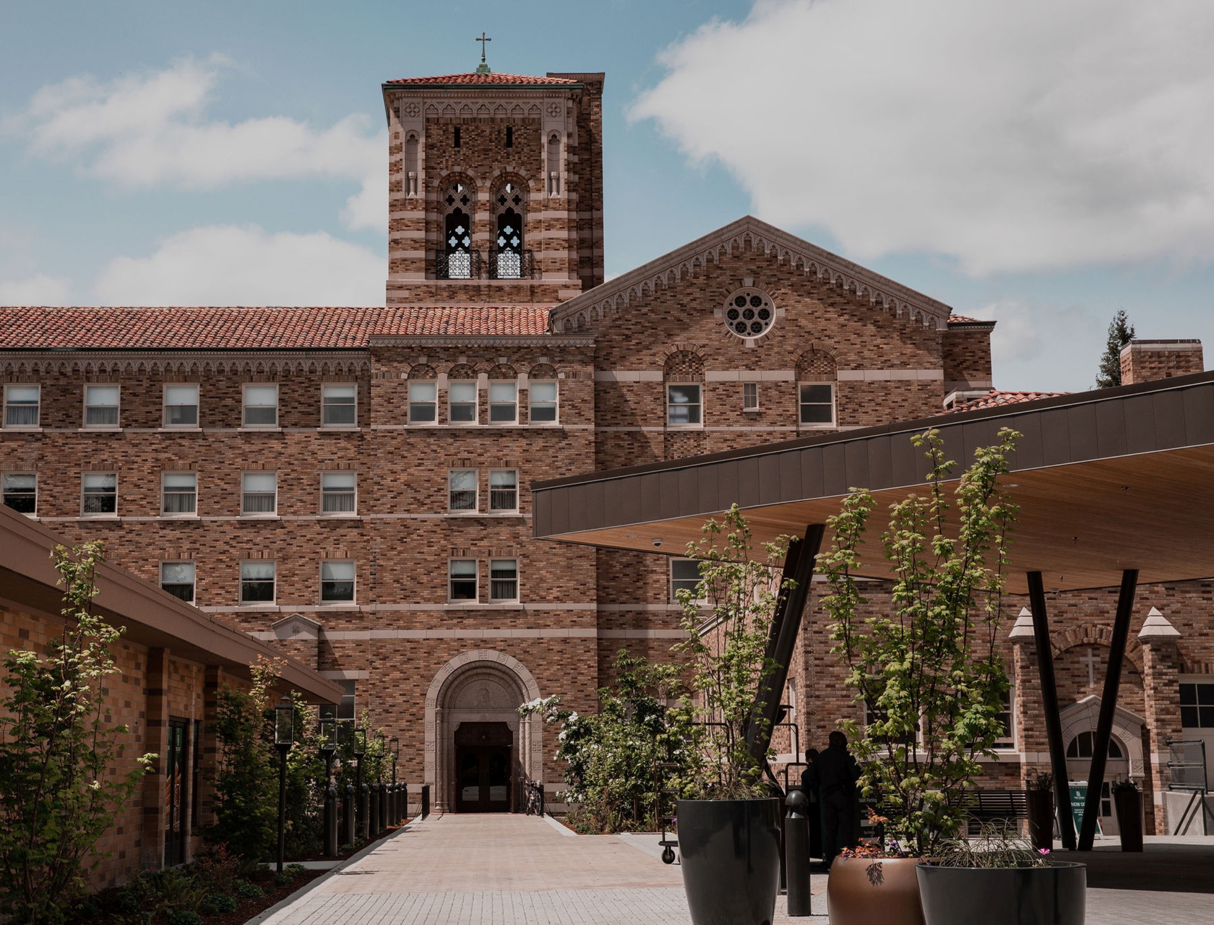 Exterior view of main entrance to The Lodge at St. Edward Park hotel. The former seminary's bell tower is featured prominently.